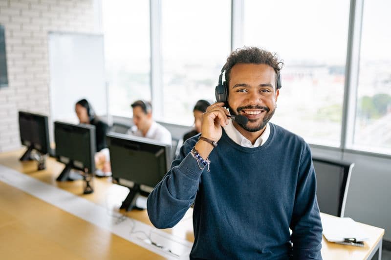 Sales agent on a call in an open office